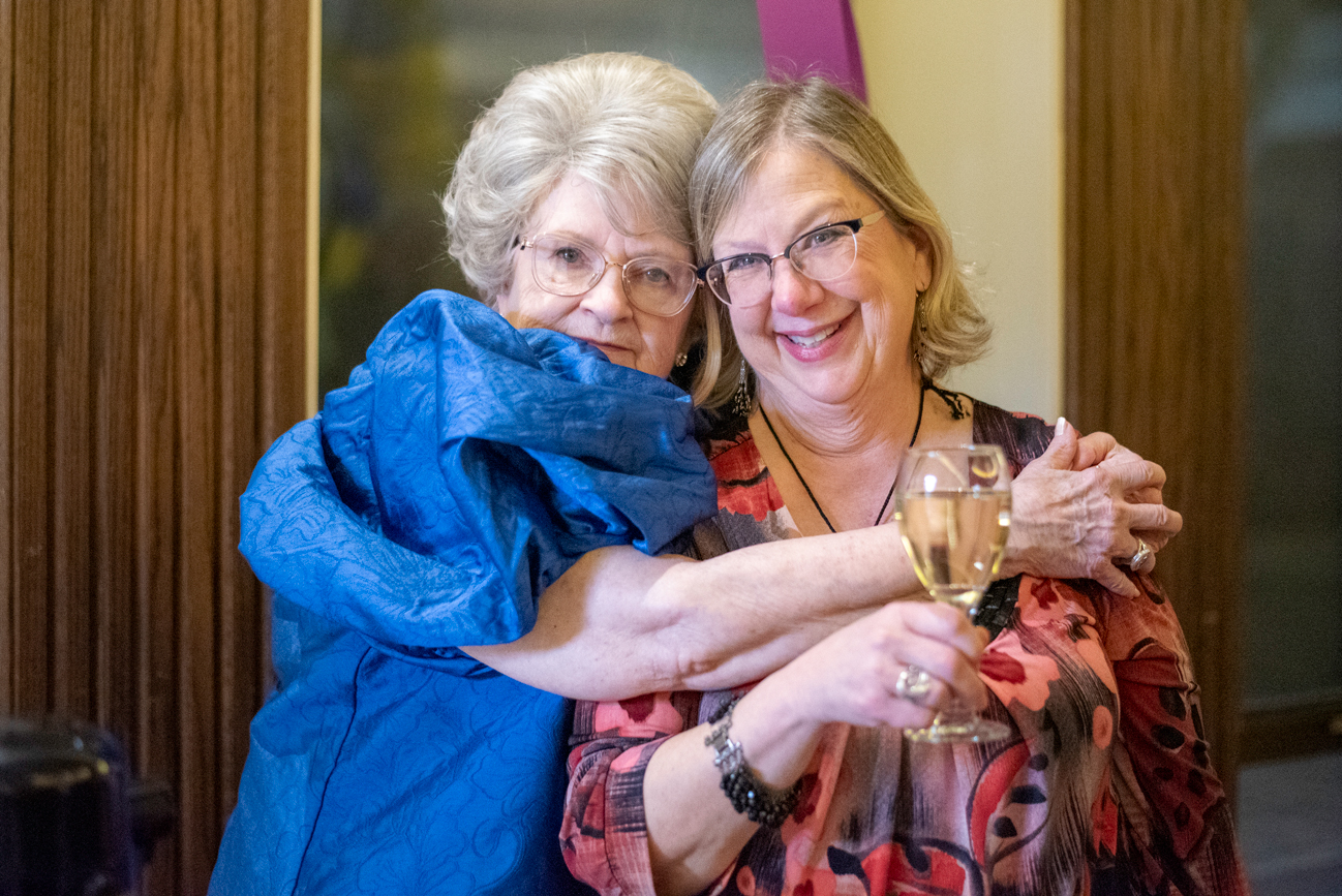 Two women smiling together at a competition reception